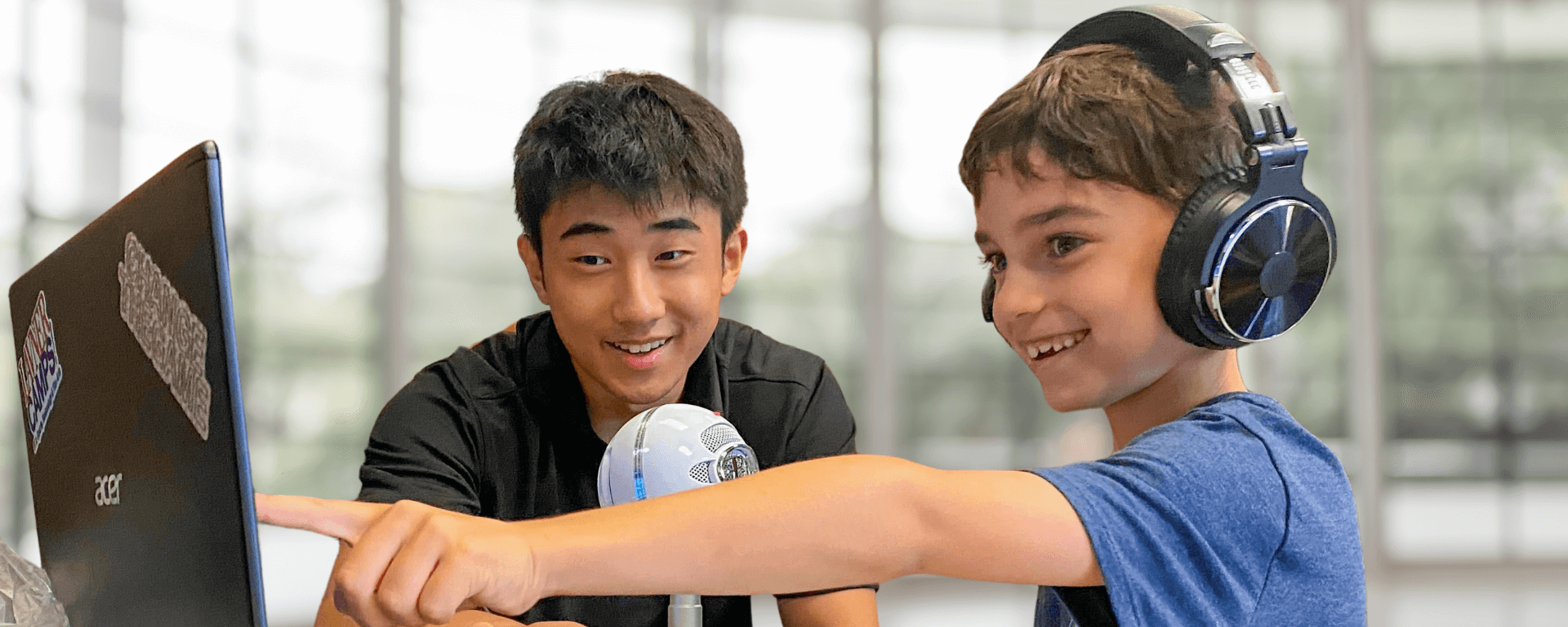 child pointing at computer screen